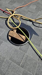 circular roof opening surrounded by shingles