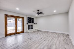 Living room with modern laminate flooring and a brick fireplace