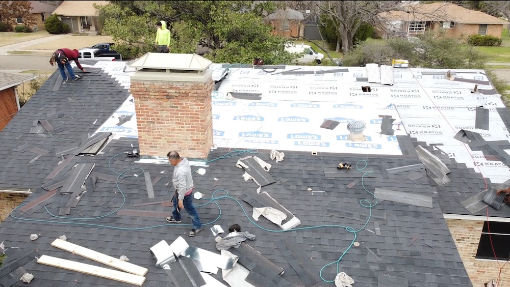 expert roofers replacing old shingles