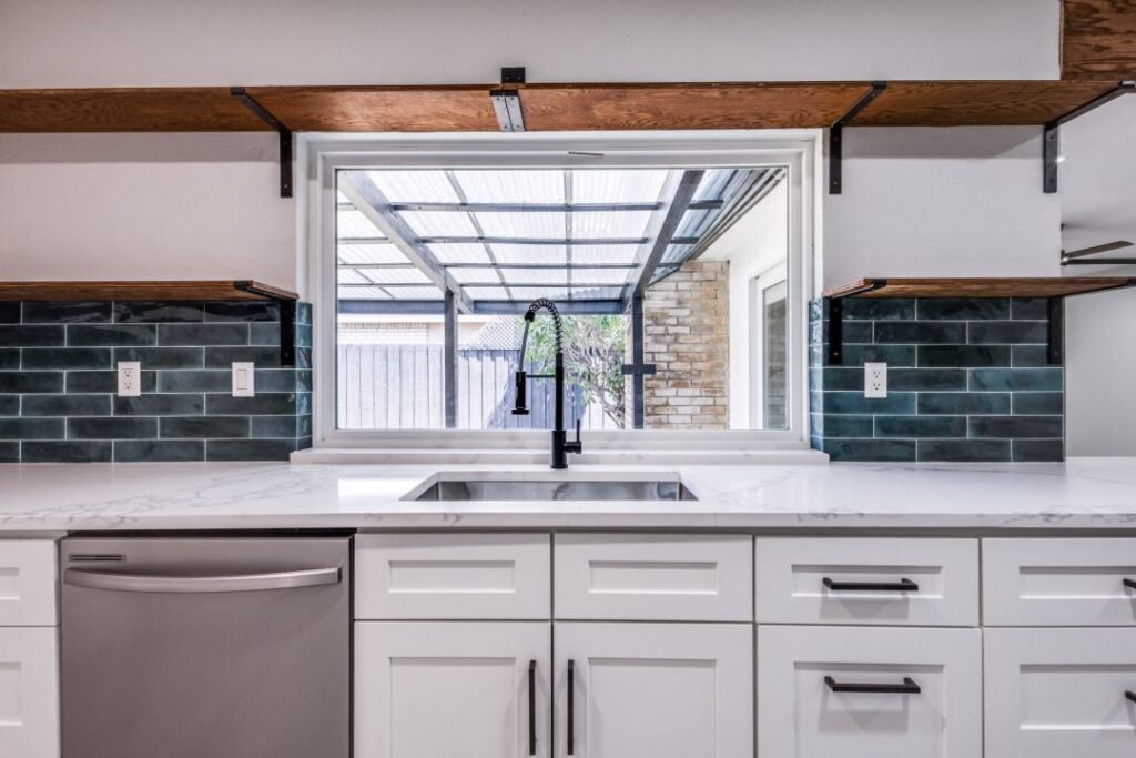 Beautiful green tile backsplash installation in Dallas, Texas, adding a modern touch to a bright white kitchen with open shelving