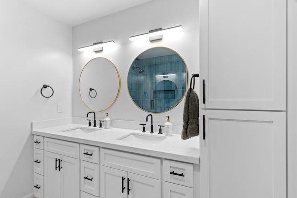 Spa-style walk-in shower and double sinks with vessel bowls highlight this warm-toned bathroom remodel Richardson, Texas residents admire.