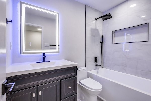 Freestanding soaking tub and glass shower enclosure showcase a recent bathtub installation in Allen, Texas.