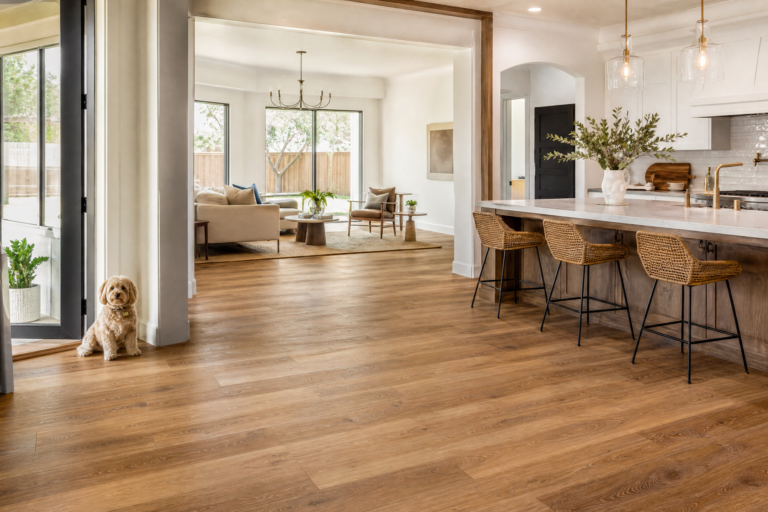 Durable wood-look flooring in a bright Dallas kitchen and living area with a small dog